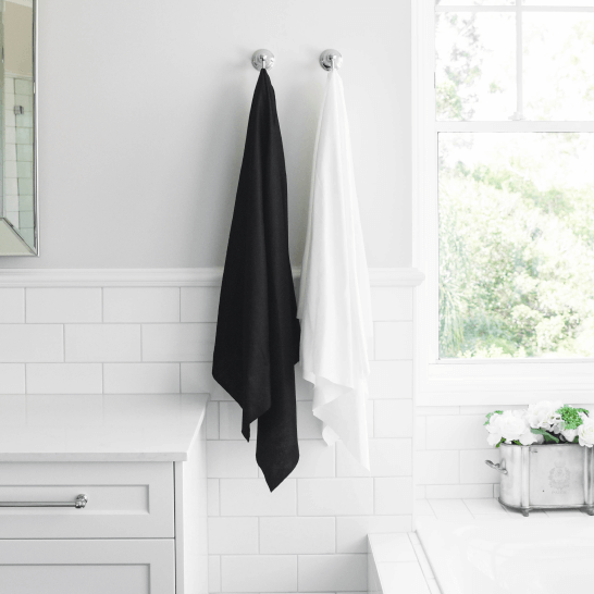 Easydry white and black bath towel or shower towel or large towel. They are shown here in a spa or bathroom.