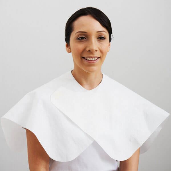 Easydry Disposable White Shoulder Cape - this cape can be secured in place and is adjustable. Seen here on a clients shoulders.