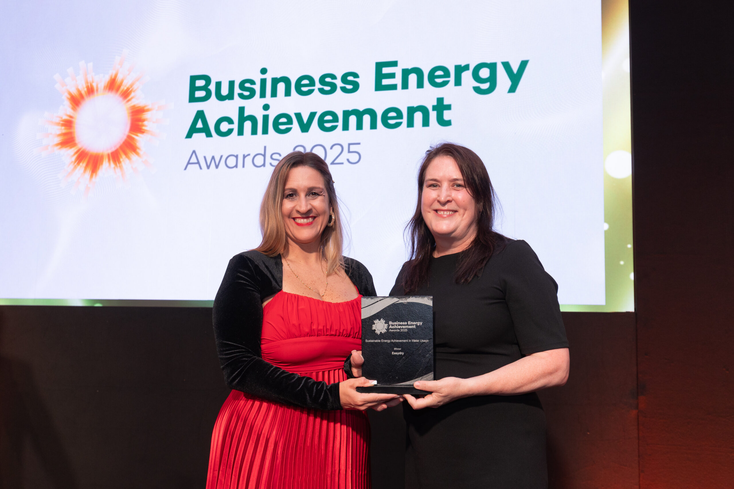 Easydry CEO Anne Butterly accepting the Sustainable Energy Achievement in Water Usage Award 2025 for compostable salon towels.