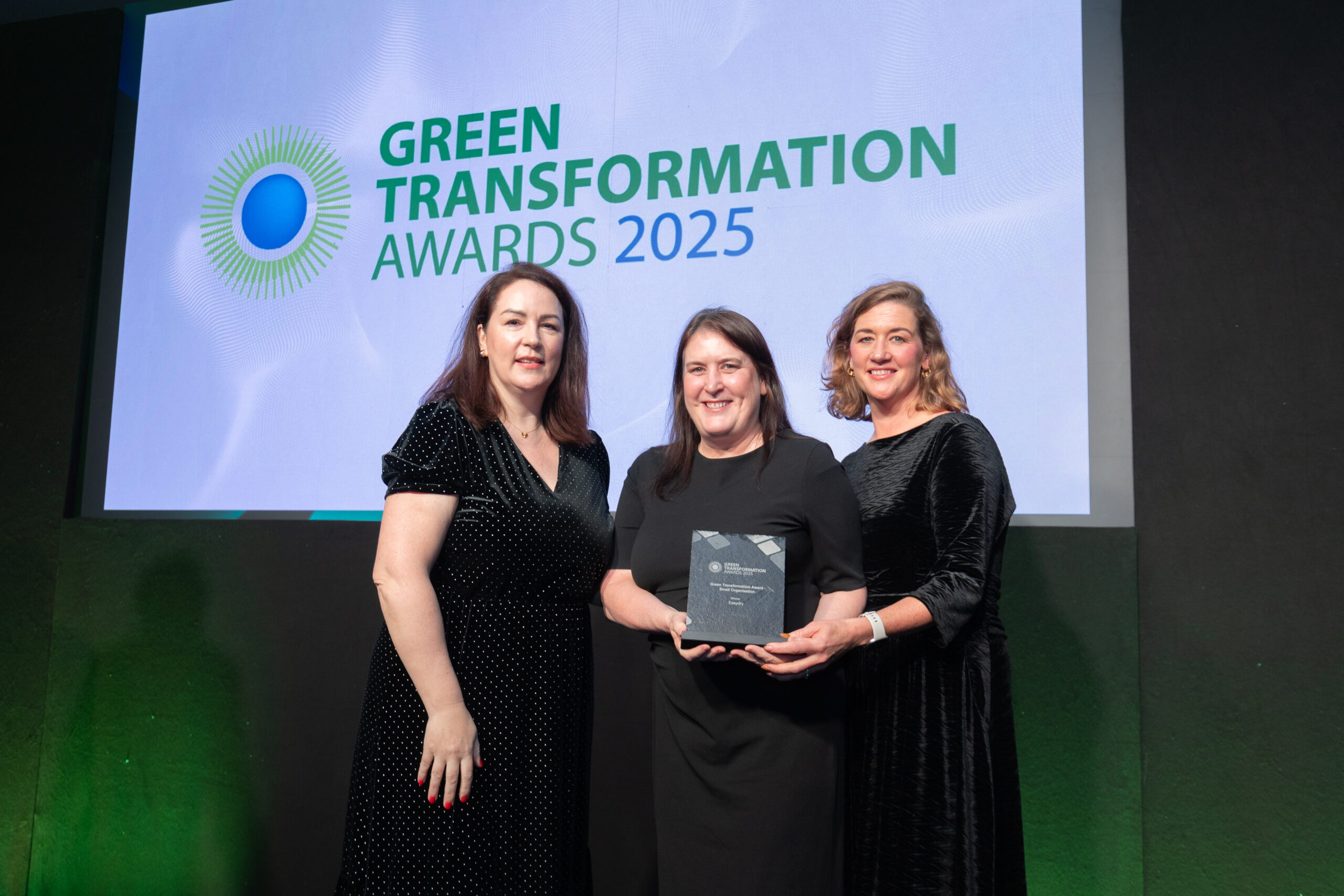 Rhonda Doyle, Awards Judge and Country President of Schneider Electric Ireland, presenting the Green Transformation Award trophy to Anne Butterly, CEO & Founder of Easydry, and Emma Reilly, Marketing Manager, at the 2025 Green Transformation Awards.